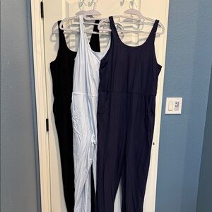 Set of Three Sleeveless Jumpsuits - Black, Light Blue, and Navy by Zyia.